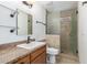 Bathroom features a tiled shower with a glass door, vanity, and tile flooring at 2110 E Laguna Dr, Tempe, AZ 85282