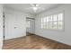 Airy bedroom with wood-look floors, ceiling fan and sliding mirror closet doors at 2110 E Laguna Dr, Tempe, AZ 85282