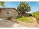 Charming single-story home with a well-maintained lawn, mature shade tree, and a paved driveway at 2110 E Laguna Dr, Tempe, AZ 85282