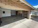 View of a garage featuring concrete flooring, built-in shelving, and convenient overhead lighting at 2110 E Laguna Dr, Tempe, AZ 85282