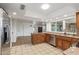 Kitchen with stainless steel appliances, wood cabinets, and adjacent to the living room at 2110 E Laguna Dr, Tempe, AZ 85282