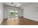 A bright living room featuring wood floors and a sliding glass door to backyard at 2110 E Laguna Dr, Tempe, AZ 85282