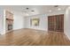 Living room with stylish flooring, a stone fireplace, and a view of the arched window and front door at 2110 E Laguna Dr, Tempe, AZ 85282