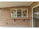 This covered outdoor patio features a countertop and serving window, great for entertaining guests at 2110 E Laguna Dr, Tempe, AZ 85282