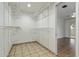 Spacious walk-in closet featuring built-in shelving and tile flooring, perfect for organization at 2110 E Laguna Dr, Tempe, AZ 85282