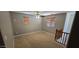 Neutral-toned loft space featuring two windows, a ceiling fan, and carpeted floors at 21402 E Alyssa Rd, Queen Creek, AZ 85142