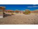 Expansive gravel backyard with mature trees and an outdoor fire pit at 2149 S Olivewood --, Mesa, AZ 85209