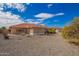 The backyard features gravel landscaping, a covered patio, and a red tile roof at 2149 S Olivewood --, Mesa, AZ 85209