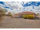 A backyard view featuring low-maintenance gravel landscaping and a covered patio at 2149 S Olivewood --, Mesa, AZ 85209