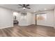 Bright bedroom features wood-look flooring, a ceiling fan, and natural light from a window, enhancing the room's appeal at 2149 S Olivewood --, Mesa, AZ 85209