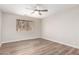 Bedroom features wood-look flooring, ceiling fan, natural light from window creating a welcoming and cozy space at 2149 S Olivewood --, Mesa, AZ 85209