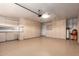 Spacious garage with epoxy flooring, abundant storage cabinets, and overhead lighting at 2149 S Olivewood --, Mesa, AZ 85209