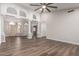 Spacious living room featuring wood floors, columns, arches, and high ceilings at 2149 S Olivewood --, Mesa, AZ 85209