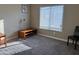 Bright bedroom featuring neutral carpet and walls, a lamp, and modern seating at 2150 W Alameda Rd # 1119, Phoenix, AZ 85085