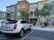 View of the exterior showing the townhome-style condos and an parked SUV in front at 2150 W Alameda Rd # 1119, Phoenix, AZ 85085