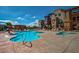 A community pool with lounge chairs and nearby apartments set under a partly cloudy sky at 2150 W Alameda Rd # 1119, Phoenix, AZ 85085