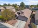 Aerial view of a desert home with a tile roof, desert landscaping, and a two-car garage at 21867 N Kirkland Dr, Maricopa, AZ 85138