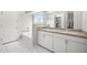 Elegant bathroom featuring a double vanity, granite countertop, and separate tub at 21867 N Kirkland Dr, Maricopa, AZ 85138