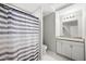 Bathroom featuring striped shower curtain, white vanity, and granite countertop at 21867 N Kirkland Dr, Maricopa, AZ 85138