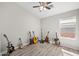 Bright bedroom with a ceiling fan, window, and guitars displayed along the wall, creating a music room atmosphere at 21867 N Kirkland Dr, Maricopa, AZ 85138