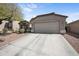 View of a single Gathering home with desert landscaping and a driveway leading to a two-car garage at 21867 N Kirkland Dr, Maricopa, AZ 85138