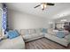 Spacious living room featuring a large sectional sofa and wood-look flooring at 21867 N Kirkland Dr, Maricopa, AZ 85138