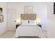 Serene bedroom featuring a tufted headboard, soft lighting, and minimalist decor for a relaxing retreat at 2401 W Los Arboles Pl, Chandler, AZ 85224