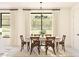 Cozy dining room with natural light, showcasing a wooden table with six chairs and modern lighting at 2401 W Los Arboles Pl, Chandler, AZ 85224