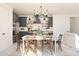 Bright dining area open to the kitchen features a stylish chandelier and a dining table with seating at 2401 W Los Arboles Pl, Chandler, AZ 85224