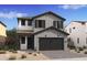 Charming two-story home featuring neutral siding, a two-car garage, and a covered entryway at 2401 W Los Arboles Pl, Chandler, AZ 85224