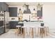 Contemporary kitchen featuring gray cabinetry, stainless appliances, and a center island with seating at 2421 W Los Arboles Pl, Chandler, AZ 85224