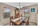 Inviting dining room with a wooden table set, hutch, and bright natural light from multiple windows at 24848 W Kowalsky Ln, Buckeye, AZ 85326