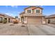 Two-story home boasting a two-car garage, beige stucco, and desert landscaping at 24848 W Kowalsky Ln, Buckeye, AZ 85326