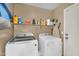 Laundry room with a washer, dryer, shelving, and storage solutions at 24848 W Kowalsky Ln, Buckeye, AZ 85326