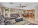 Open-concept living room seamlessly flows into dining area, showcasing natural light and modern decor at 24848 W Kowalsky Ln, Buckeye, AZ 85326