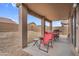 Covered patio with outdoor seating and a grill overlooking the spacious backyard at 24848 W Kowalsky Ln, Buckeye, AZ 85326