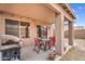 Covered patio featuring outdoor seating, a grill, and views of the backyard at 24848 W Kowalsky Ln, Buckeye, AZ 85326