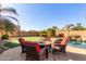 Beautiful backyard setup with outdoor seating, fire pit, putting green, and pool at 2830 E Janelle Way, Gilbert, AZ 85298