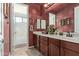 Bathroom boasts double sinks, custom wallpaper and a view of the bathtub through a door at 2830 E Janelle Way, Gilbert, AZ 85298