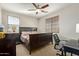 This bedroom features a dark bed frame, bedside tables, and a functional desk area at 2830 E Janelle Way, Gilbert, AZ 85298