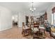 Charming dining area features a round glass table and flows seamlessly into a spacious kitchen, ideal for gatherings at 2830 E Janelle Way, Gilbert, AZ 85298