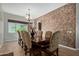 Elegant dining room features a dark wood table with seating for eight and a textured accent wall at 2830 E Janelle Way, Gilbert, AZ 85298