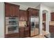 Modern kitchen showcases stainless steel appliances and dark wood cabinetry at 2830 E Janelle Way, Gilbert, AZ 85298