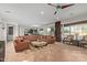 Expansive living room with a sectional sofa, tile floors, and abundant natural light, creating a welcoming ambiance at 2830 E Janelle Way, Gilbert, AZ 85298