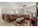 Comfortable living room features plush seating, decorative rug, ceiling fan, and natural light at 2830 E Janelle Way, Gilbert, AZ 85298