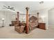 Luxury main bedroom features a four-poster bed with a ceiling fan and neutral carpet at 2830 E Janelle Way, Gilbert, AZ 85298