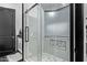 Modern bathroom showcasing a glass enclosed shower with decorative tile and black hardware at 29501 N 76Th St, Scottsdale, AZ 85266