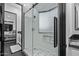 Bathroom featuring a glass shower with patterned tile and black framed hardware at 29501 N 76Th St, Scottsdale, AZ 85266