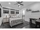 Bedroom with a gray upholstered bed and several windows at 29501 N 76Th St, Scottsdale, AZ 85266