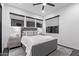 Bedroom with an upholstered bed and a gray rug and black framed windows at 29501 N 76Th St, Scottsdale, AZ 85266